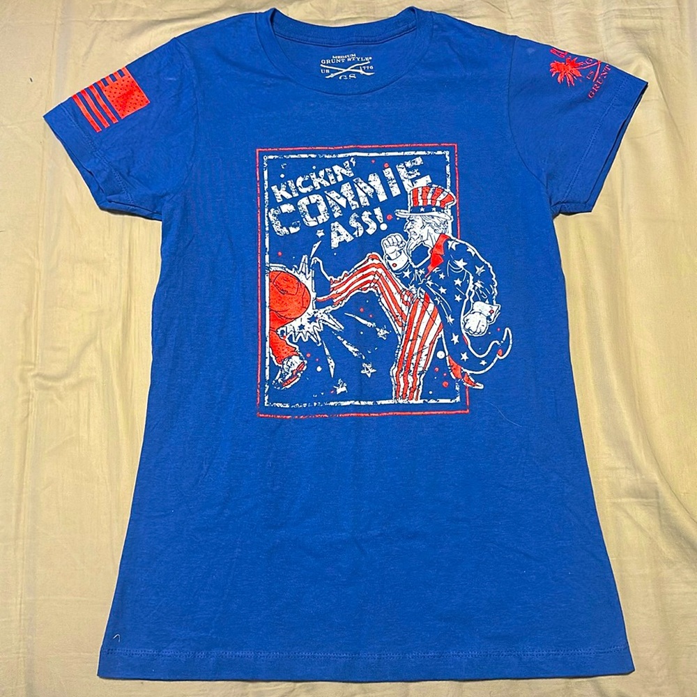Club Grunt Style Exclusive. Women’s medium fit. Blue, graphics red, white & blue
